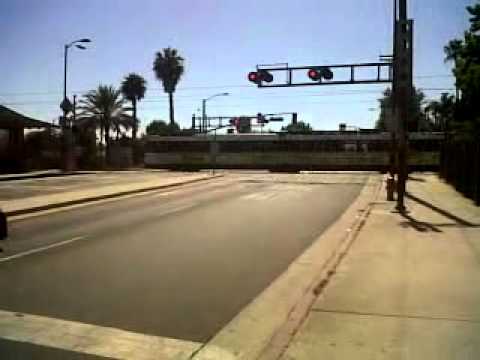 Blue Line crossing 103rd St after Watts Towers Station